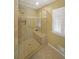 Modern tiled shower with glass doors, a built-in seat, and a rainfall shower head at 1001 Wiley Bridge Rd, Woodstock, GA 30188