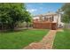 A view of the backyard highlighting lush grass and the home's raised deck at 1796 Center Ave, East Point, GA 30344