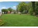 Lush backyard featuring a well manicured lawn, shed, and mature trees at 1796 Center Ave, East Point, GA 30344