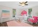 Charming bedroom featuring a pink theme, complemented by natural light creating a cheerful atmosphere at 1796 Center Ave, East Point, GA 30344