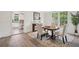 Formal dining room with hardwood floors, stylish chairs, and a view into the kitchen at 1796 Center Ave, East Point, GA 30344