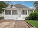 Inviting white home with a screened-in porch and brick-lined walkway leading to the entrance at 1796 Center Ave, East Point, GA 30344