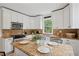 Bright kitchen featuring white cabinets, an island with seating, and modern appliances at 1796 Center Ave, East Point, GA 30344