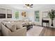 Cozy living room with a large sectional sofa, bright windows, and stylish decor at 1796 Center Ave, East Point, GA 30344