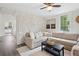 Bright living room featuring a stone accent wall, neutral sectional sofa, and modern decor at 1796 Center Ave, East Point, GA 30344
