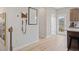 Entryway with kitchen view and convenient storage solutions like a calendar and key hooks at 208 Maycrest Path, Tucker, GA 30084