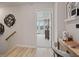 Hallway and desk area offering a view into a sunlit bedroom and decoratively styled wall at 208 Maycrest Path, Tucker, GA 30084