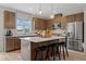 Modern kitchen featuring stainless steel appliances, island with seating, and stylish pendant lighting at 208 Maycrest Path, Tucker, GA 30084