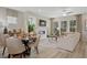 Cozy living room with fireplace, dining area, and large windows filling the space with natural light at 208 Maycrest Path, Tucker, GA 30084