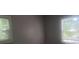 A bedroom with gray walls and two windows at 2835 Burton Rd, Atlanta, GA 30311