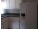 A basic kitchen with white cabinets and a white refrigerator at 2835 Burton Rd, Atlanta, GA 30311