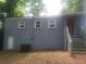 Rear exterior of the home with gray siding and steps up to the back entrance at 2835 Burton Rd, Atlanta, GA 30311