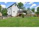 Expansive backyard featuring a well-maintained lawn, wooden fence, and screened-in porch at 5600 Surrey Ct, Alpharetta, GA 30009