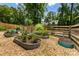 Lush backyard showcasing raised garden beds, gravel ground cover, and a wood fence at 5600 Surrey Ct, Alpharetta, GA 30009