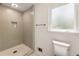 Updated bathroom with a tiled walk-in shower, tiled floors, and a frosted glass window at 5600 Surrey Ct, Alpharetta, GA 30009