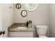 Half bath featuring granite counters, ample lighting, and round mirrors at 5600 Surrey Ct, Alpharetta, GA 30009