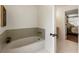 Bathroom with a soaking tub and views to a bedroom at 5600 Surrey Ct, Alpharetta, GA 30009
