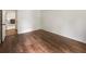 Empty bedroom with hardwood floors and a single window at 5600 Surrey Ct, Alpharetta, GA 30009