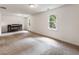 Spacious bedroom featuring plush carpeting, windows for natural light, and decorative fireplace at 5600 Surrey Ct, Alpharetta, GA 30009
