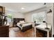 Bedroom with hardwood floors, large windows, and a built-in headboard at 5600 Surrey Ct, Alpharetta, GA 30009