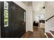 Inviting entryway with a dark wood door, hardwood floors, and a glimpse into the cozy living room at 5600 Surrey Ct, Alpharetta, GA 30009