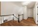 Upstairs hallway with hardwood floors, white walls, and black railing at 5600 Surrey Ct, Alpharetta, GA 30009