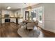 Bright kitchen boasts stainless steel appliances, granite countertops, and an adjacent dining area with a bay window at 5600 Surrey Ct, Alpharetta, GA 30009