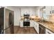 Modern kitchen featuring stainless steel appliances, granite countertops, and white cabinetry at 5600 Surrey Ct, Alpharetta, GA 30009