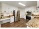 Well-lit kitchen with stainless appliances, granite counters, and ample white cabinetry at 5600 Surrey Ct, Alpharetta, GA 30009