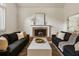 Inviting living room featuring a brick fireplace and stylish seating area at 5600 Surrey Ct, Alpharetta, GA 30009