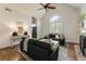 Open living space with a vaulted ceiling, hardwood floors, and a fireplace as a focal point at 5600 Surrey Ct, Alpharetta, GA 30009
