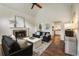 Bright living room with hardwood floors, vaulted ceilings, a cozy fireplace, and modern decor at 5600 Surrey Ct, Alpharetta, GA 30009