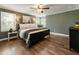 Spacious bedroom with large windows, hardwood floors, and a ceiling fan at 5600 Surrey Ct, Alpharetta, GA 30009