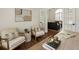 Well appointed office with hardwood floors and a view into the living room at 5600 Surrey Ct, Alpharetta, GA 30009