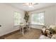 Bright home office with natural light, hardwood floors, and comfortable seating at 5600 Surrey Ct, Alpharetta, GA 30009