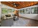 Inviting sunroom featuring a wood ceiling, a plush seating area, and a modern sauna at 5600 Surrey Ct, Alpharetta, GA 30009