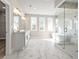 Spacious primary bath with a double vanity, soaking tub, and frameless glass shower at 5627 Meadowstone Walk, Kennesaw, GA 30152
