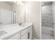 Bright bathroom featuring double vanity with quartz countertop and modern fixtures at 5627 Meadowstone Walk, Kennesaw, GA 30152