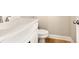 Bathroom featuring a white vanity, toilet, hardwood flooring, and neutral walls, creating a clean and modern space at 5627 Meadowstone Walk, Kennesaw, GA 30152
