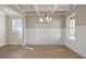 Elegant dining room with coffered ceilings, wainscoting, hardwood floors, and natural light from large windows at 5627 Meadowstone Walk, Kennesaw, GA 30152