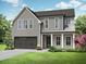 Beautiful two-story home with gray siding, a covered porch, manicured landscaping, and an attached two car garage at 5627 Meadowstone Walk, Kennesaw, GA 30152