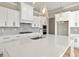 Kitchen island with a sink and faucet, quartz countertop, and stainless steel appliances, perfect for cooking at 5627 Meadowstone Walk, Kennesaw, GA 30152