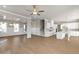 Open-concept living space featuring hardwood floors, coffered ceilings, modern lighting, and a seamless kitchen integration at 5627 Meadowstone Walk, Kennesaw, GA 30152