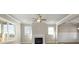 Comfortable living room with hardwood floors, fireplace, abundant natural light, and stylish ceiling fan at 5627 Meadowstone Walk, Kennesaw, GA 30152