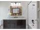 Bathroom with decorative mirror above dark vanity with granite counter and subway tile shower/tub at 2908 Mabry Ne Ln, Brookhaven, GA 30319