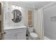 Well-lit bathroom showcasing a vanity, round mirror, and a bathtub with a shower featuring white subway tile at 2908 Mabry Ne Ln, Brookhaven, GA 30319
