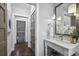 Hallway and bathroom with a sink vanity, pendant lights, and a decorative mirror at 2908 Mabry Ne Ln, Brookhaven, GA 30319