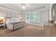 A nicely decorated bedroom featuring a tray ceiling, white bedding, and natural light from the shuttered windows at 2908 Mabry Ne Ln, Brookhaven, GA 30319