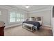 Bright and spacious bedroom featuring shuttered windows, a ceiling fan, and a comfortable bench at the foot of the bed at 2908 Mabry Ne Ln, Brookhaven, GA 30319