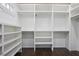 Spacious walk-in closet with custom shelving and dark wood floors at 2908 Mabry Ne Ln, Brookhaven, GA 30319
